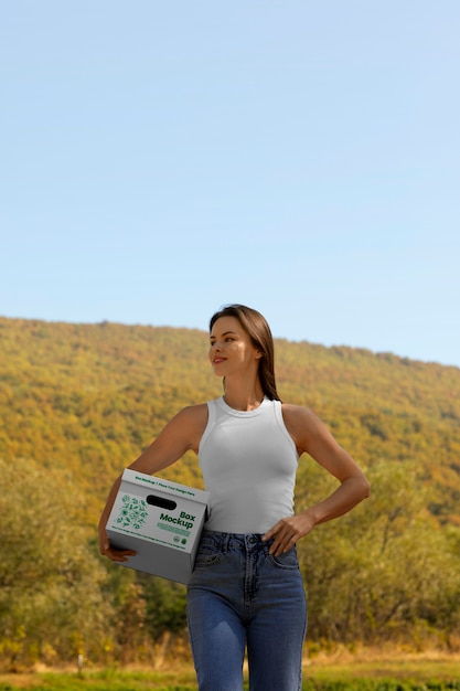 PSD front view woman holding box