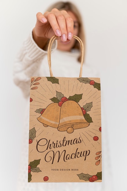 PSD front view of woman holding christmas paper bag