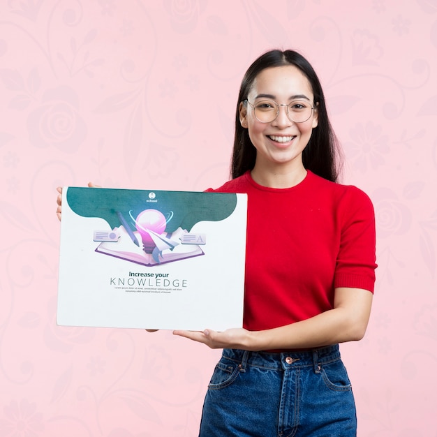 front view woman holding a mock-up ad for courses