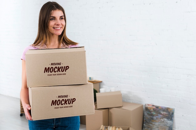 PSD front view of woman holding moving boxes mock-up