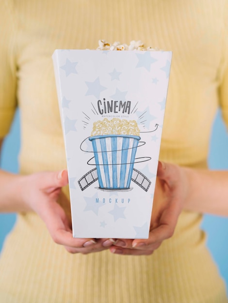 front view of woman holding popcorn cup