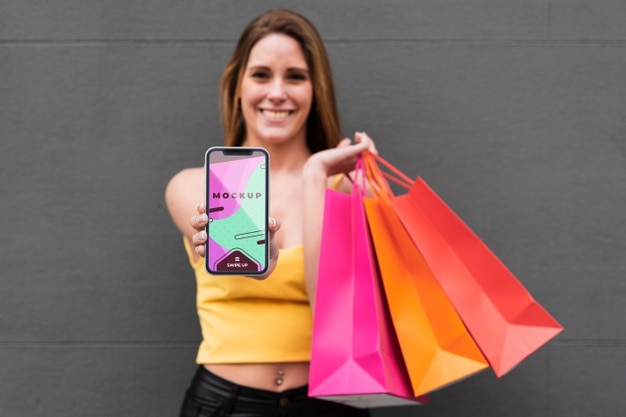 PSD front view woman holding smartphone