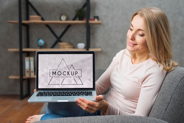 PSD front view of woman on sofa holding laptop