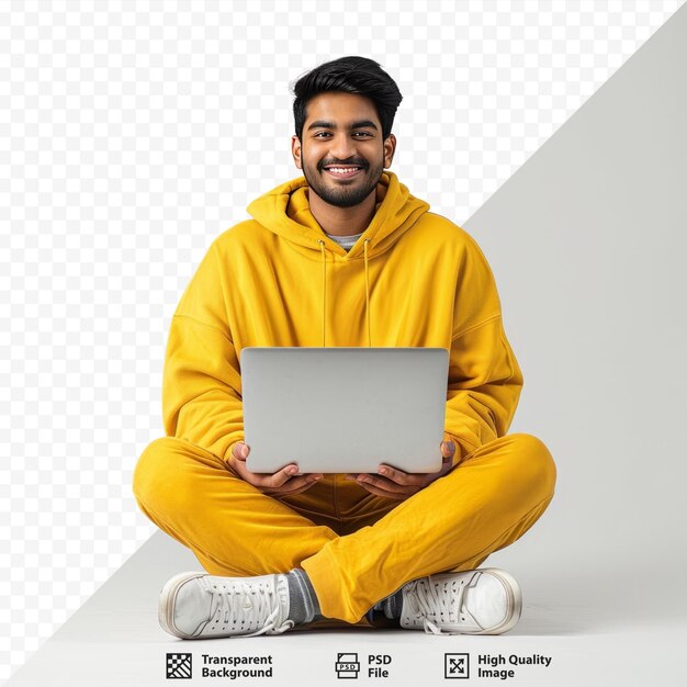 PSD full body happy young it indian man 20s he wearing casual yellow hoody sitting using holding working on laptop pc computer isolated on plain grey isolated background studio portrait people life