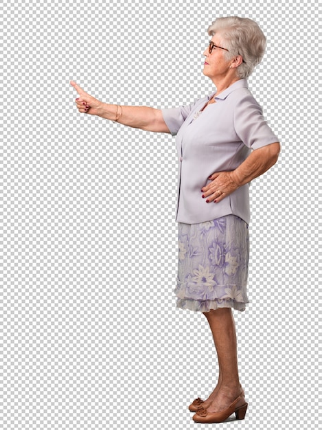 PSD full body senior woman pointing to the side, smiling surprised presenting something, natural and casual