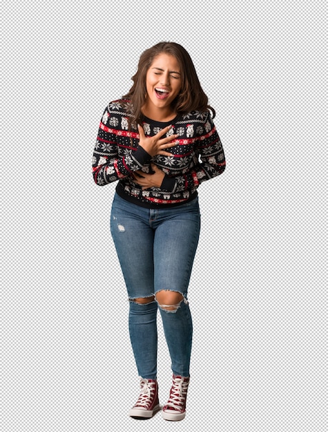 Full body young woman wearing a christmas jersey laughing and having fun