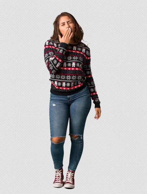 Full body young woman wearing a christmas jersey tired and very sleepy