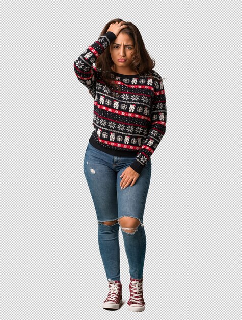 Full body young woman wearing a christmas jersey tired and very sleepy