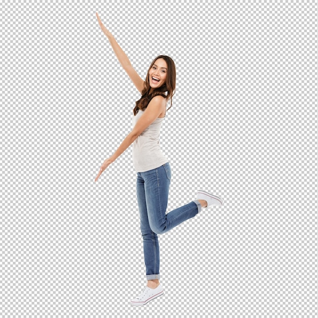 full length of cheerful brunette woman presents copyspace and looking at the camera over gray