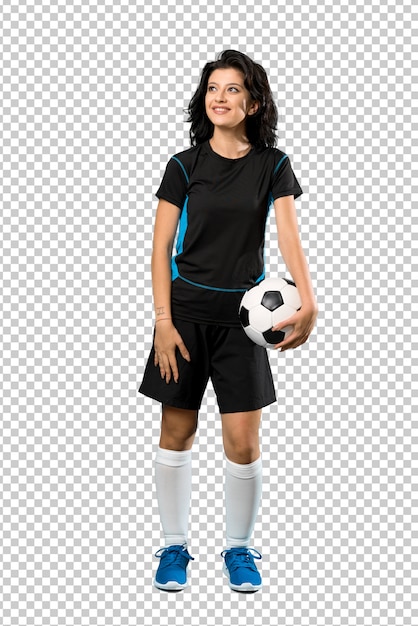 A full length shot of a young football player woman looking up while smiling