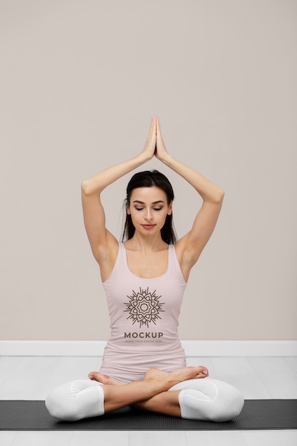 PSD full shot woman doing yoga on mat