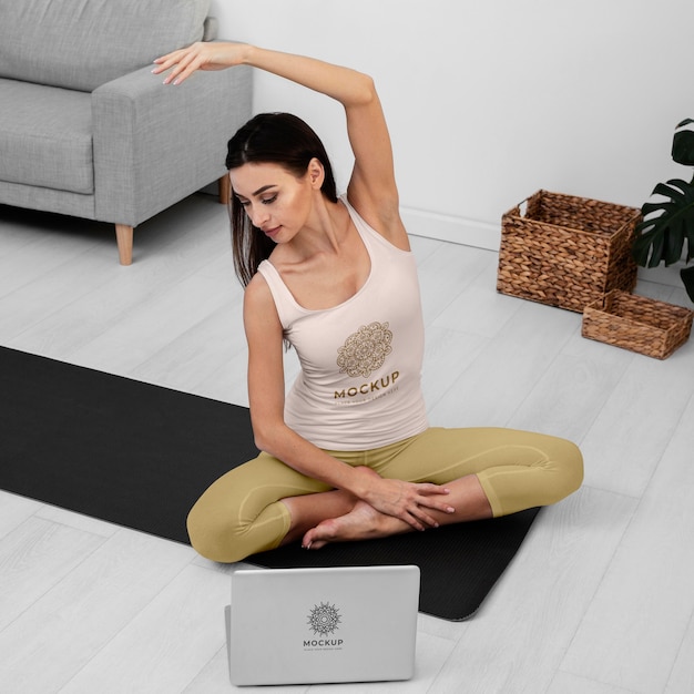 PSD full shot woman meditating on yoga mat