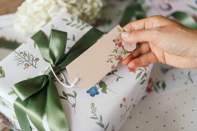 PSD gift box wrapped with floral patterned paper with a card mockup