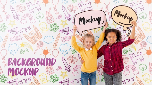 PSD girl and boy holding mock-up chat bubbles