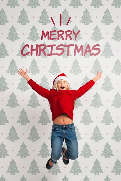 Girl dressed in red for christmas jumping