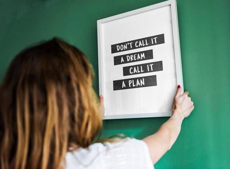 PSD girl hanging a frame on a green wall