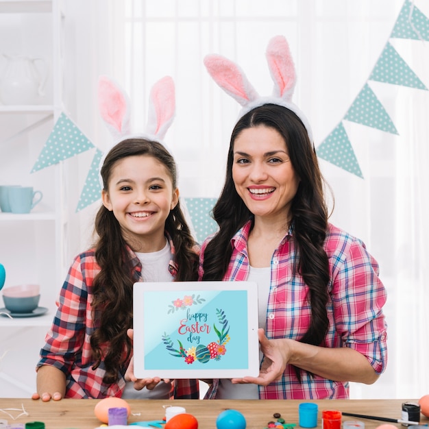 Girl and mother with tablet mockup on easter day