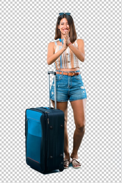 PSD girl traveling with her suitcase smiling and applauding