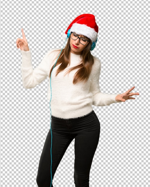 Girl with celebrating the christmas holidays listening to music with headphones and dancing