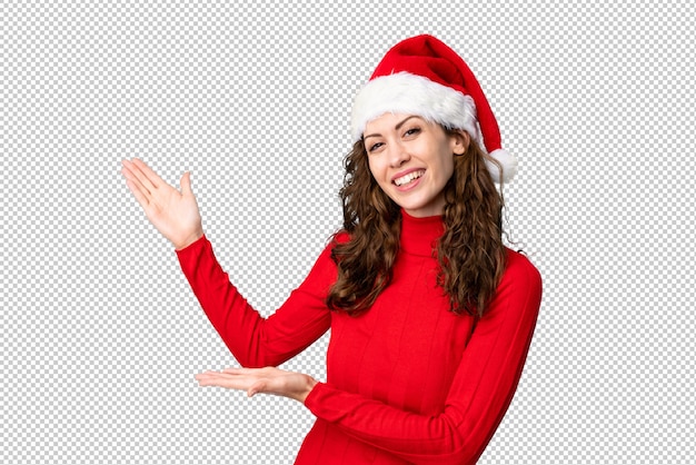 Girl with christmas hat extending hands to the side for inviting to come