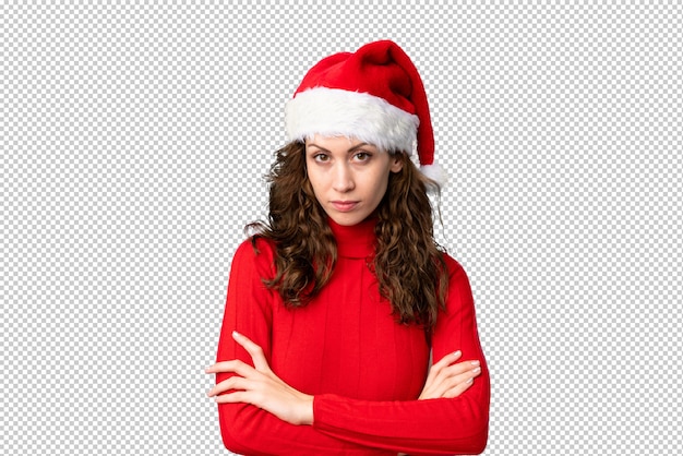 Girl with christmas hat keeping arms crossed