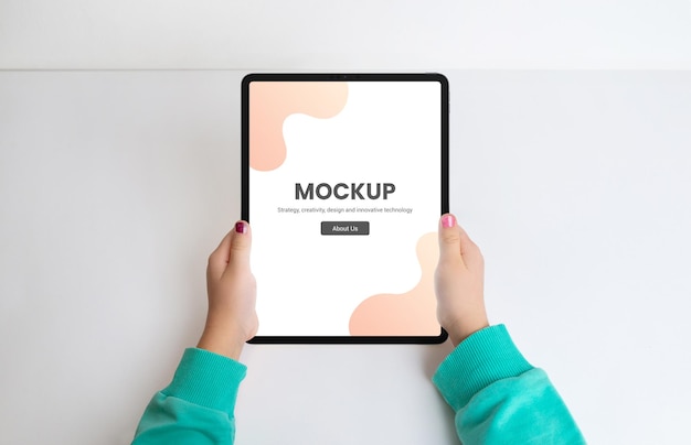 PSD girls hands with tablet in a top view flat lay mockup