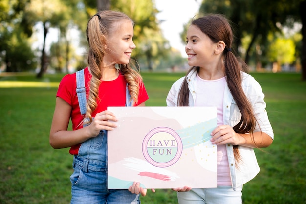 Girls holding together paper with motivational message