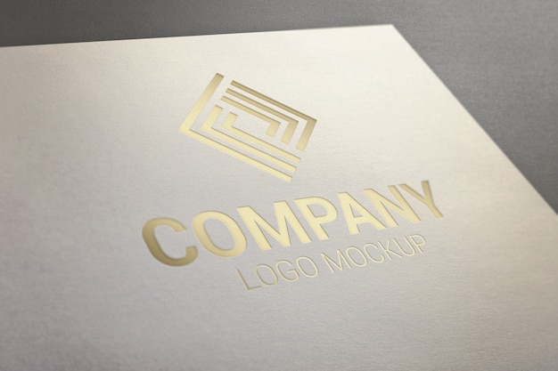 Gold glossy logo mockup on paper.