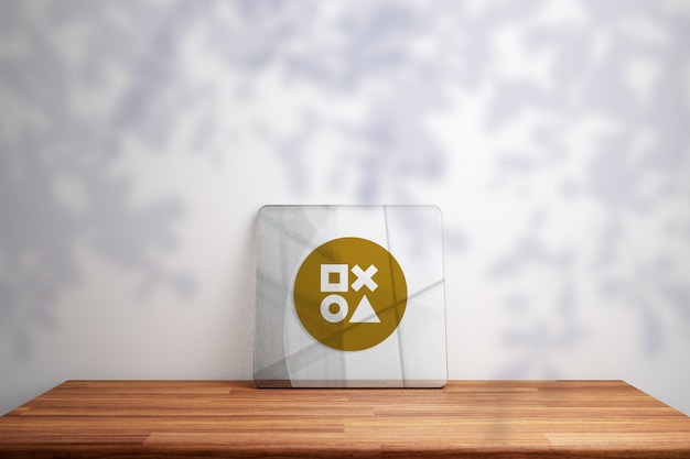 Gold logo mockup on glass on wooden table