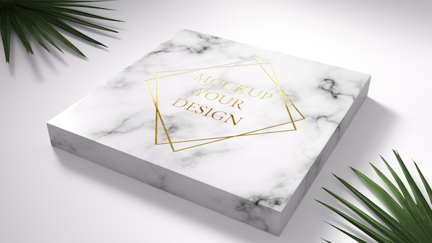 PSD gold logo mockup on marble with green leaves