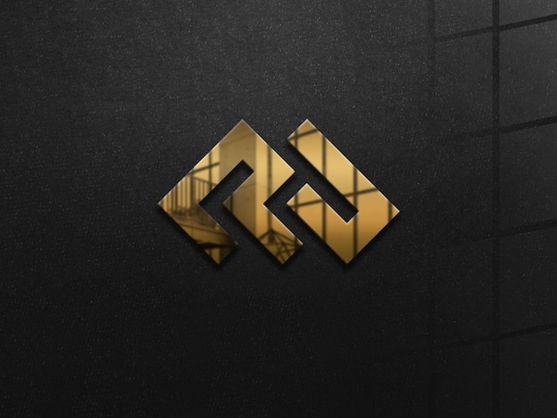 Макет золотого логотипа на черной стене