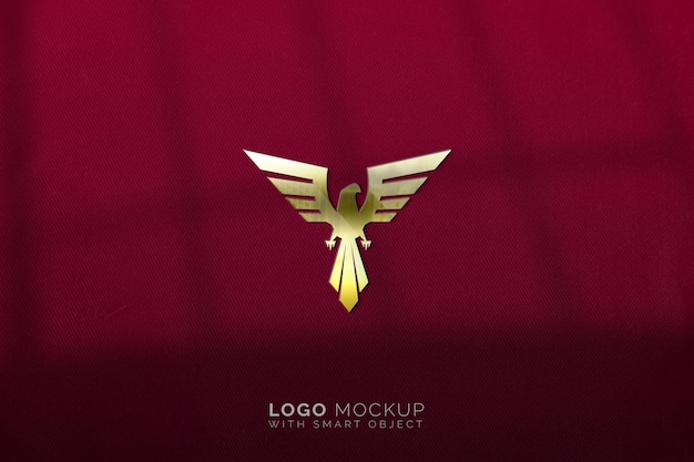 Golden eagle logo mockup on red fabric texture