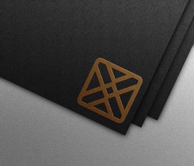 Golden embossed logo mockup on black paper