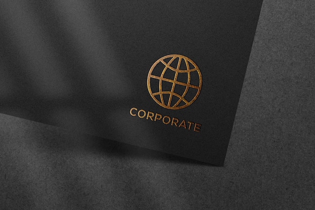 Golden embossed mockup logo on black paper texture