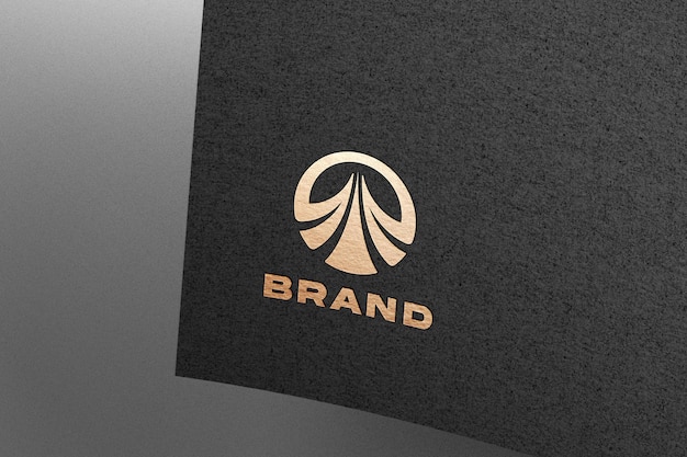 Golden logo mockup embossed on black paper