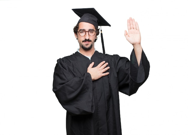 graduate bearded man smiling confidently while making a sincere promise or oath