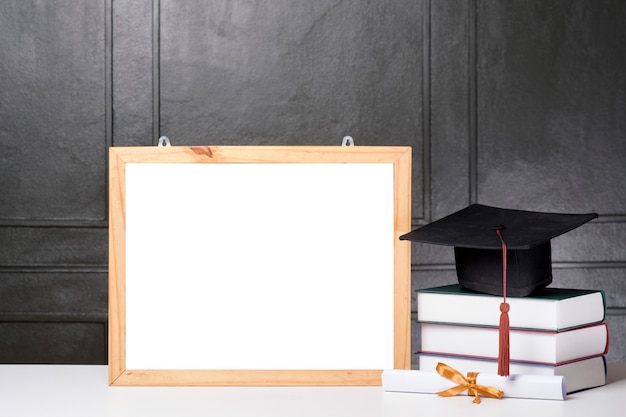 Graduation cap and book with frame mockupGraduation cap and book with frame mockup