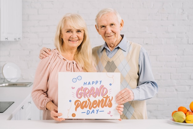 Grandparents holding placard mockup