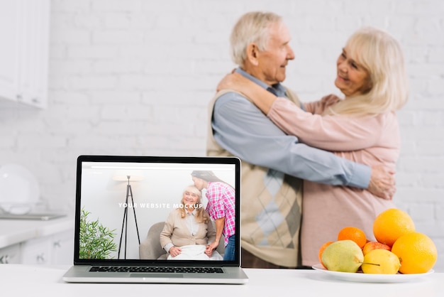 Grandparents behind laptop mockup