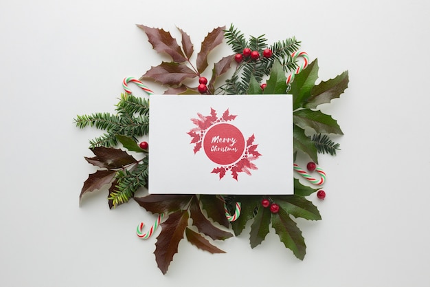 Green leaves and mock-up festive christmas decorations