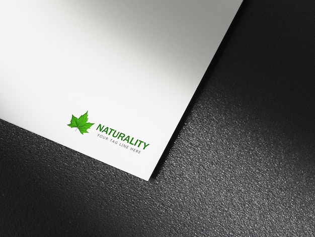 Green logo mockup on white paper with black background Premium Psd