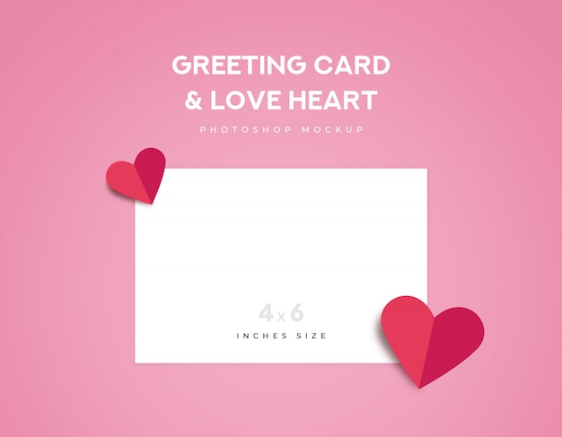 Greeting card 4x6 inches size and two red love heart origami fold on pink background