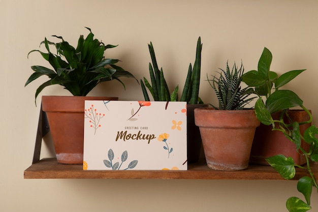 PSD greeting card mockup on shelf with plants