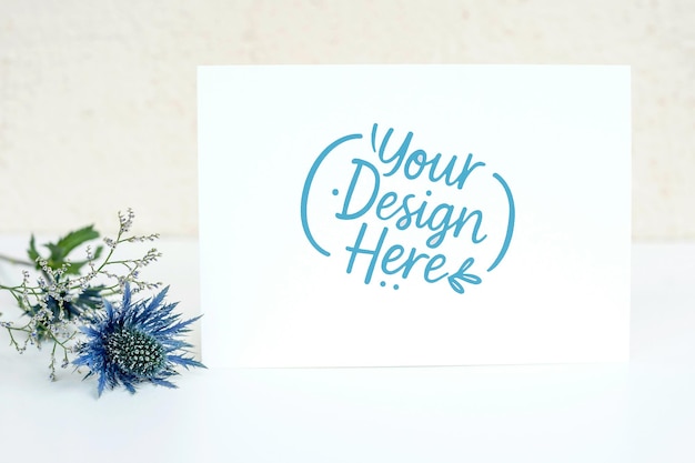 greeting card mockup with blue flower and white stationery