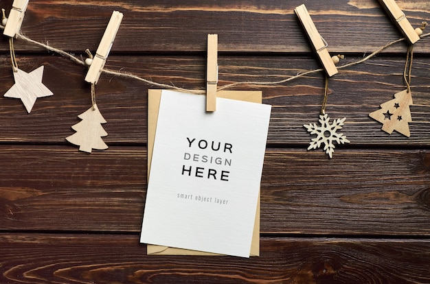 Greeting card mockup with Christmas decorations on dark wooden table