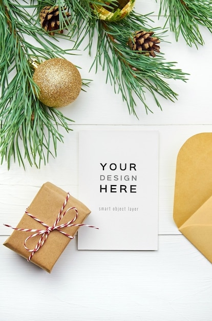 Greeting card mockup with christmas decorations on white wooden background