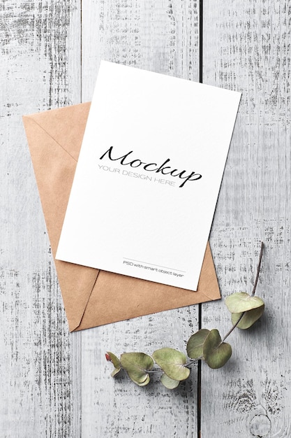 Greeting card mockup with dry eucalyptus twig on vintage wooden background