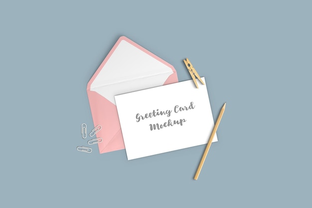 Greeting card mockup with envelope, pencil and clothespin