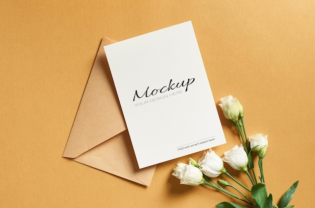 Greeting card mockup with envelope and white eustoma flowers on gold