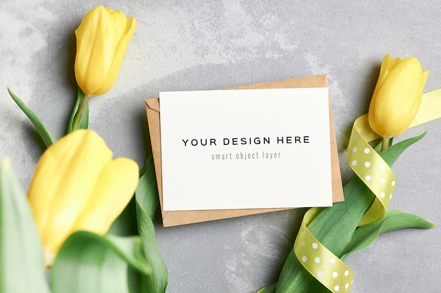 Greeting card mockup with envelope and yellow tulip flowers